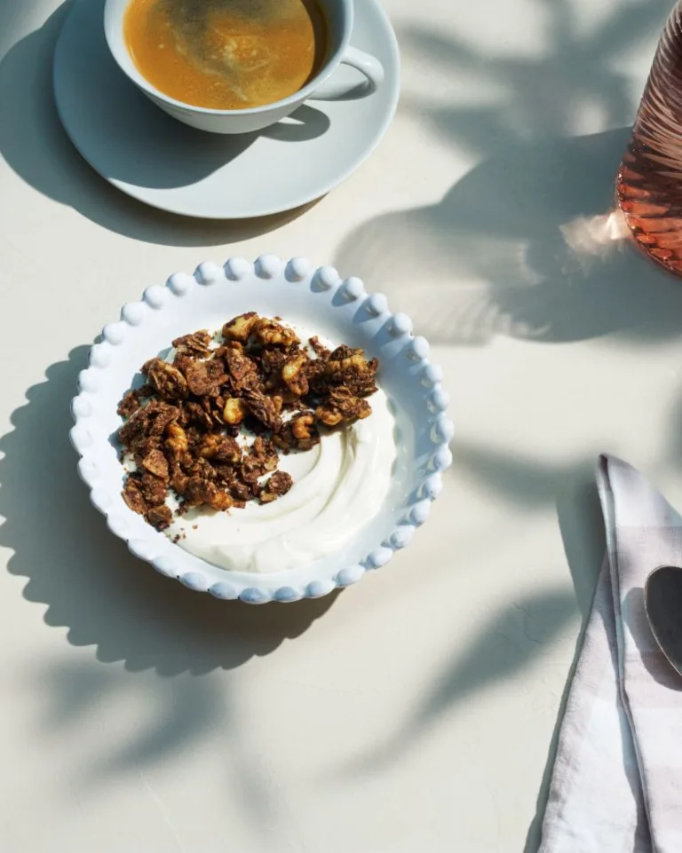 Single bowl of granola with coffee
