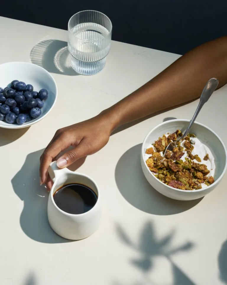 Granola with mug of coffee and berries