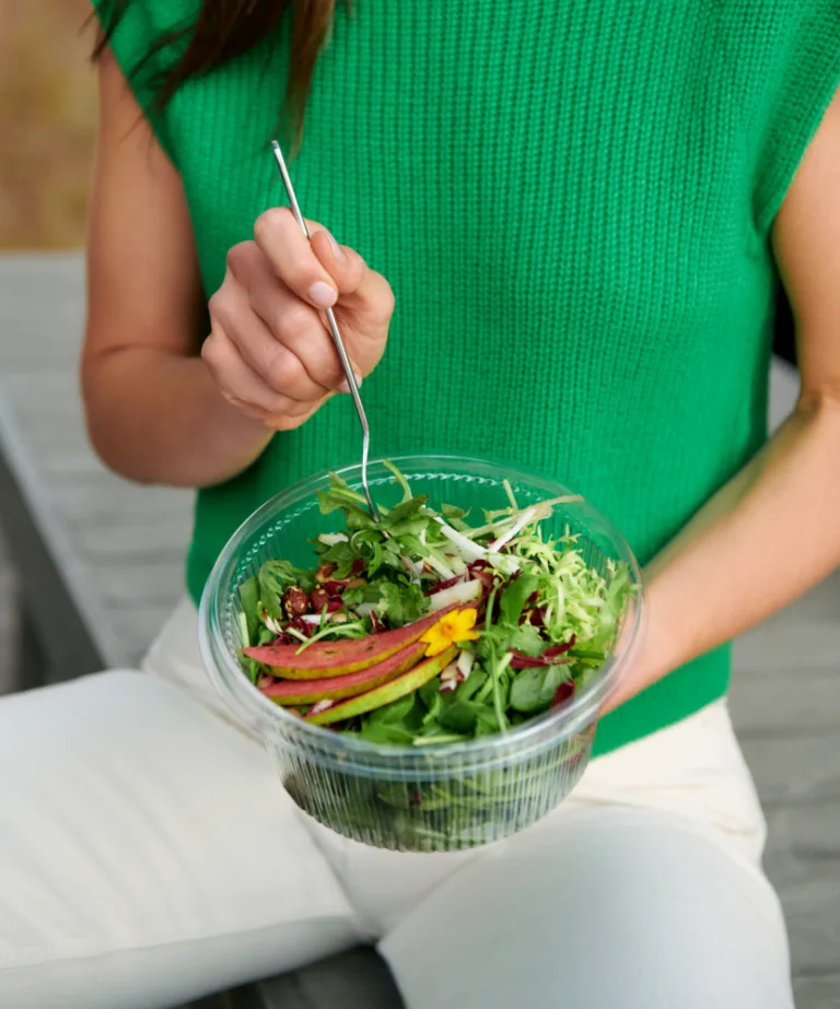 Woman in Green Eating Salad