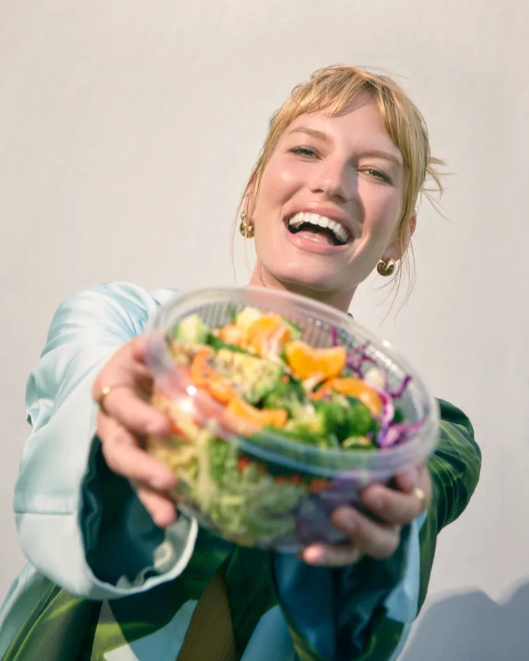 Woman presenting Salad Meal
