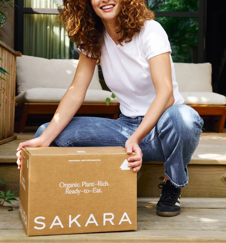 woman holding a box with nutritious meals