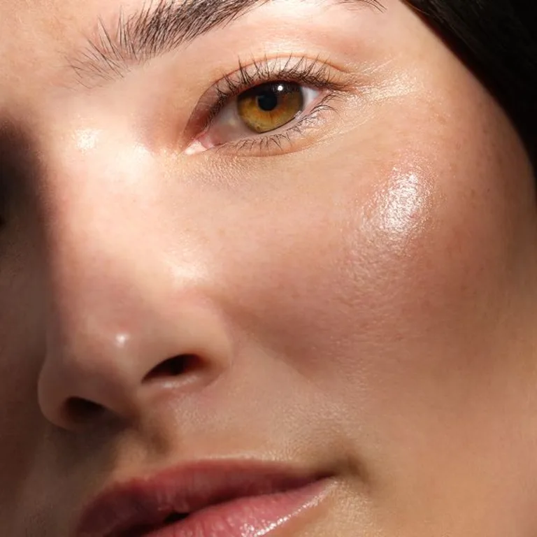 A close-up image of a female's face reflecting brightly from the sun.