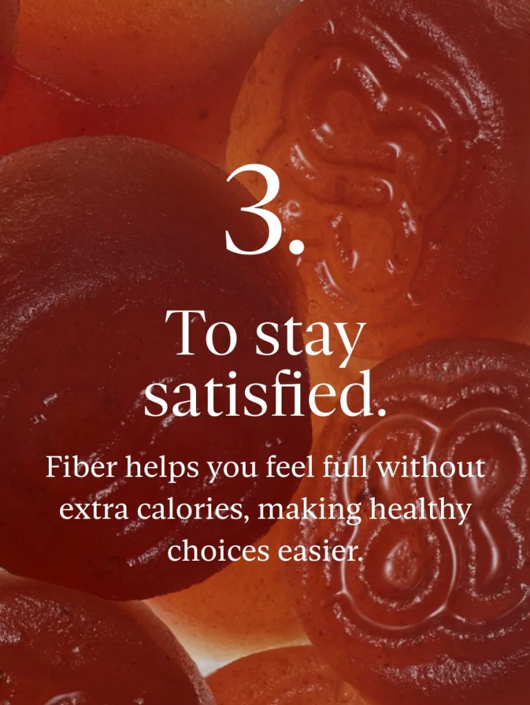 Close-up of Sakara Fiber Bite gummy with text overlay stating that the product helps "To stay satisfied."