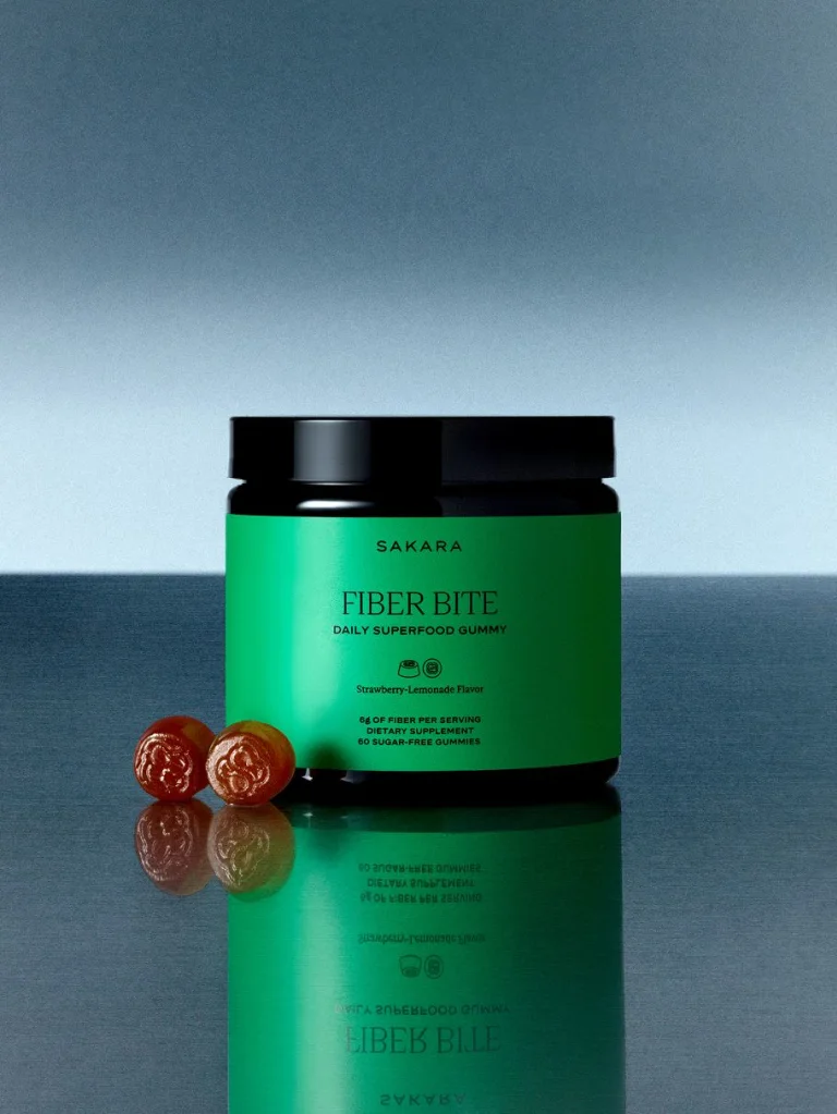 Sakara Fiber Bite packaging with green label and two pink gummies against a blue background