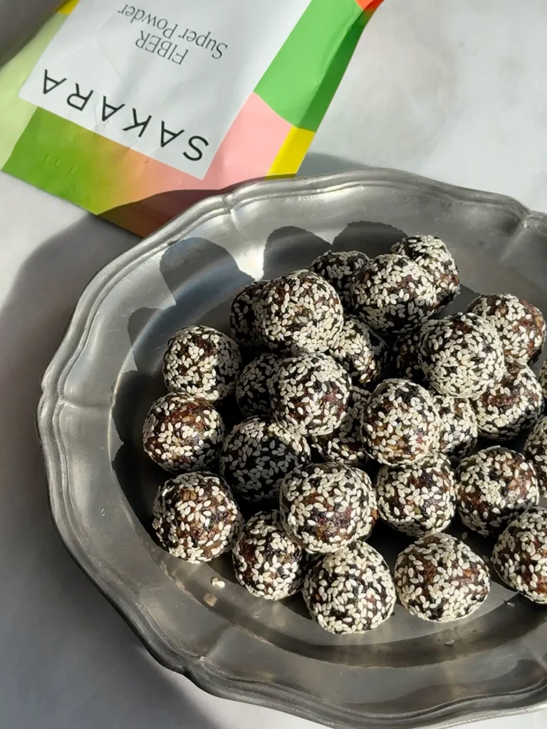 Cherry Sesame Energy Digestion Balls next to Sakara Fiber Super Powder
