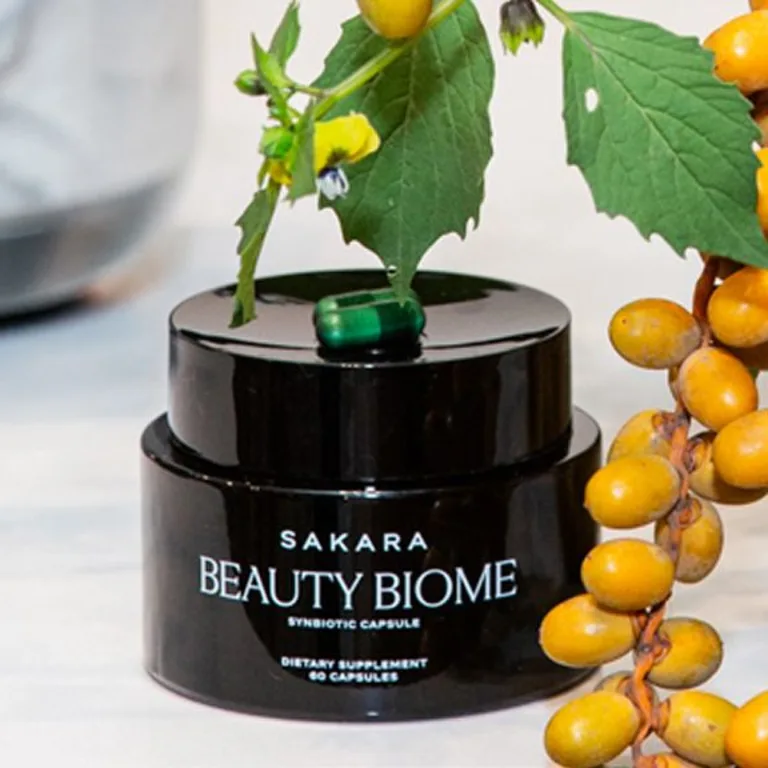 Beauty biome packaging alongside yellow berries and green leaves