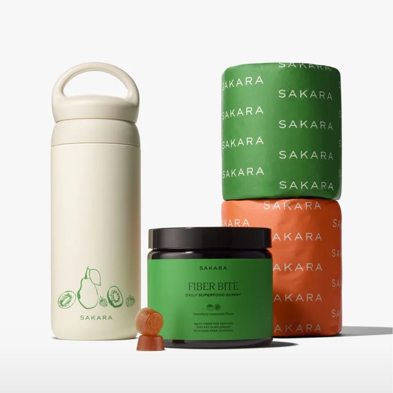 Sakara Fiber Bite, branded water bottle, and two branded toilet paper rolls