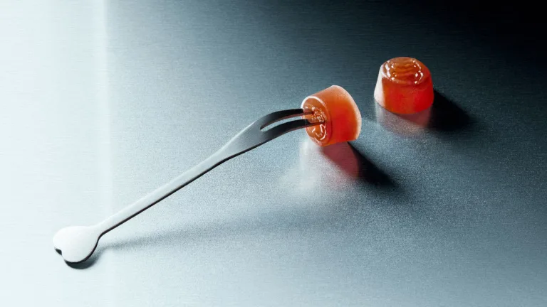 Tiny fork pinching Sakara Fiber Bite gummy