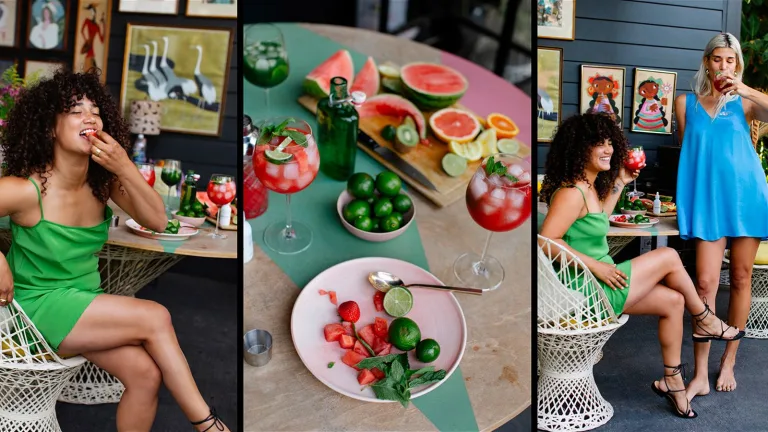 Three-panel collage of a colorful outdoor cocktail scene—left shows a woman in a bright green dress sitting in a white woven chair, smiling while eating fruit; center shows a tabletop spread with watermelon, citrus, limes, kiwi, and two red watermelon cocktails garnished with mint; right shows two women, one in green seated and one in a blue dress standing, enjoying the drinks on a patio with framed artwork and greenery behind them.