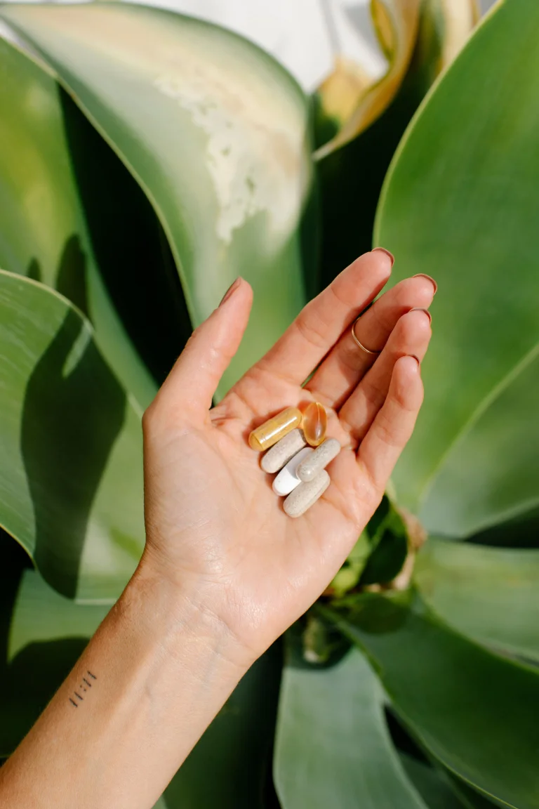 Hand holding 6 foundation pills in-hand