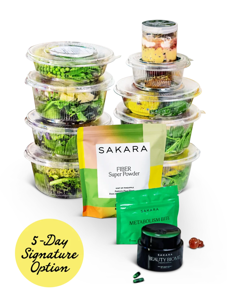 Stacked Sakara salads in plastic containers with Fiber Powder, Metabolism Bite and Beauty Biome in front with a yellow 5-Day Signature Option tag
