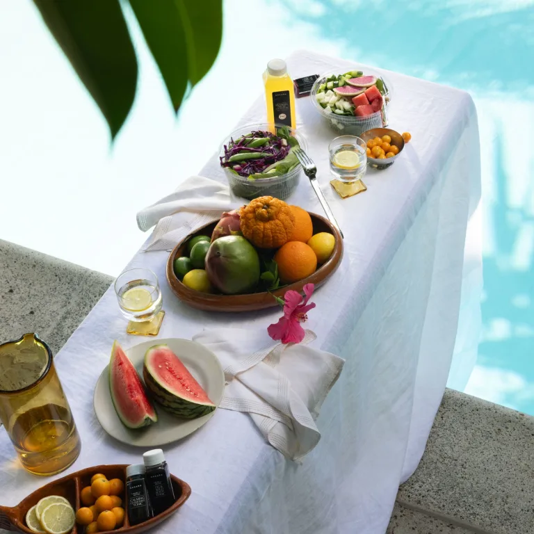 S/S Campaign 2026: set table with food on white tablecloth on a diving board 